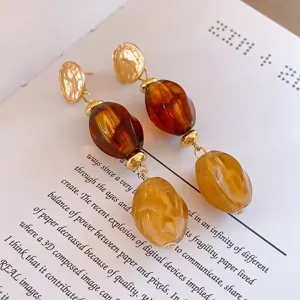 Chic long drop earrings featuring hammered gold discs and tortoiseshell acrylic beads.