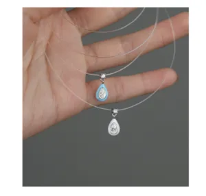 Detail shot of minimalist teardrop pendant necklace with sparkling zircon and enamel design.