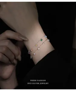 Gros plan détail du bracelet multicouche en argent S925 avec charms zirconium coloré.