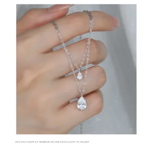 Detail view of double layer pear cubic zirconia silver necklace on hand model elegant shine