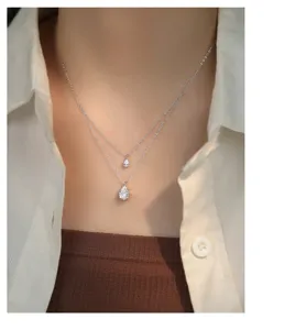 Close-up detail of double layer silver teardrop necklace sparkling design elegant jewelry.