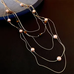 Detailed view of the multi-layer beaded pearl and tiger's eye necklace for stylish women.