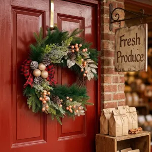 Christmas wreath for front door with red black plaid bow pine cones and berries decor.