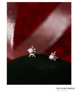 Primo piano dettagliato di orecchini a lobo in argento S925 con zirconi scintillanti.
