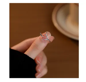 Close-up of minimalist sterling silver deer antler ring detail, elegant open finger ring style.