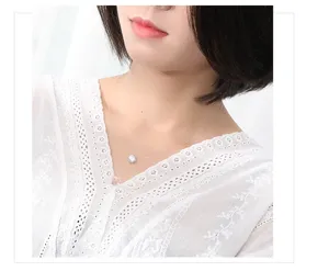 Nahaufnahme einer minimalistischen unsichtbaren Angelschnur-Halskette mit einem funkelnden Anhänger.