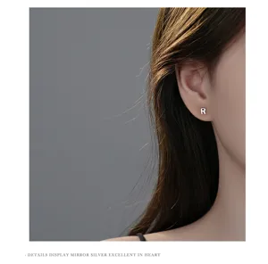 Gedetailleerd overzicht van s999 puur zilveren letter R oorknopjes, minimalistische sieraden.