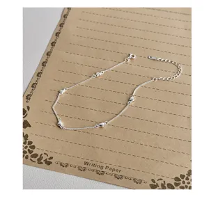 Exquisite S925 sterling silver heart anklet featuring delicate charms and adjustable extension chain.