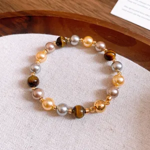 Retro Maillard style tiger eye stone and multi-color pearl beaded bracelet detail.