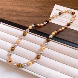 Retro Maillard tiger eye pearl beaded bracelet detail shot, elegant mixed gemstone fashion jewelry piece.