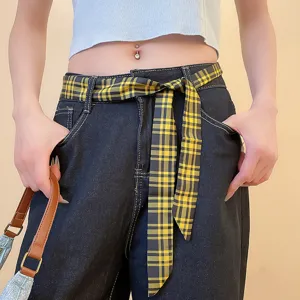 Plaid belt waist detail shot showcasing stylish yellow and black patterned fabric accessory.