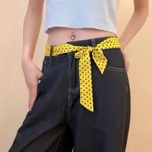 Yellow polka dot scarf belt for women, stylish waist accessory and trendy clothing decoration.