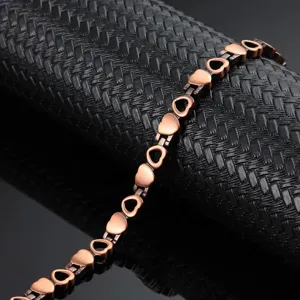 Close-up of a vintage copper magnetic therapy bracelet with interlocking heart links