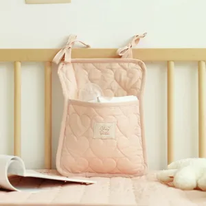 Detailansicht einer rosa herzgesteppten Babybett-Tasche mit Chez Bébé-Etikett