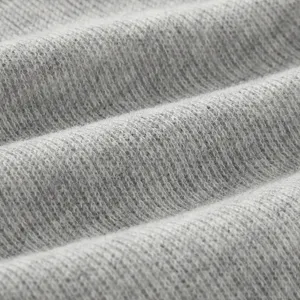Close-up of soft grey knitted fabric for infant autumn cardigan sweater jacket.