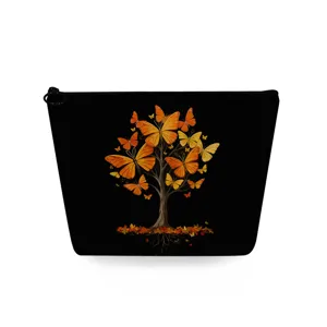 Detailed view of black cosmetic pouch featuring artistic autumn butterfly tree pattern print zipper.