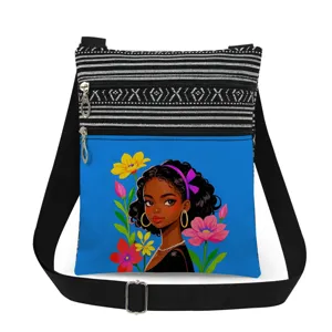 Detailed view of black girl print crossbody bag featuring double zipper and adjustable strap.