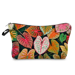 Detailed view of a stylish women's cosmetic bag featuring vibrant tropical green leaf pattern.
