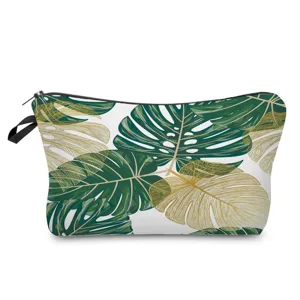 Detailed close-up view of the stylish green monstera leaf pattern cosmetic bag texture.