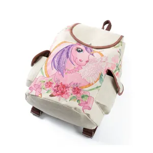 Canvas backpack detail showing the cute pink unicorn print, brown leather trim and straps.