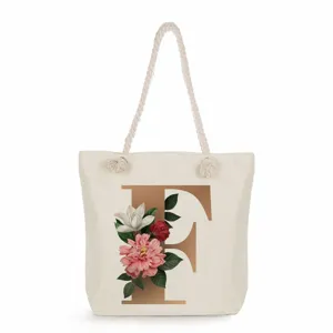 Canvas tote bag with golden letter F print, floral aesthetic style large shoulder bag.