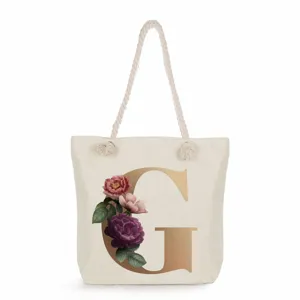 Canvas tote bag with elegant golden letter G print and floral design, large capacity shoulder bag.