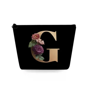 Zwarte cosmetische tas met gouden letter G en bloemenprint, draagbare make-up etui voor dames.