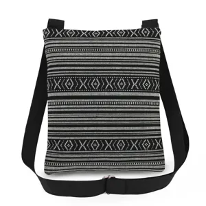 Detail view of black and white woven geometric pattern crossbody shoulder bag fabric texture.