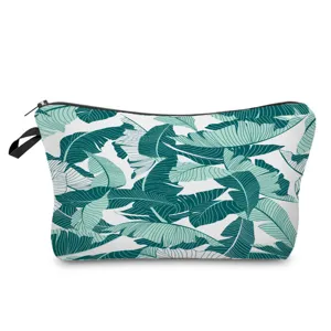 Tropical palm leaf print detail on cosmetic pouch zipper and fabric texture close-up view.