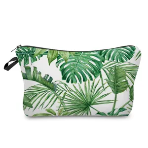 Close-up detail view of the portable cosmetic bag featuring a vibrant tropical leaf print.