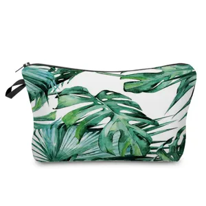 Close-up detail of the tropical green leaf printed cosmetic bag, showcasing pattern texture.