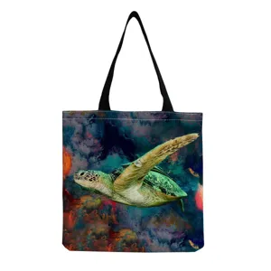Canvas tote bag close-up showing realistic sea turtle print and abstract artistic background.