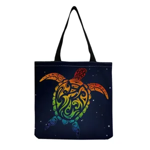 Canvas shoulder tote bag featuring colorful tribal sea turtle print for casual use.