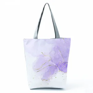 Close-up detail of the purple abstract watercolor pattern and durable grey handle on the bag.