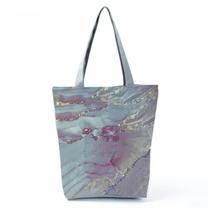 Abstract fluid print pattern detail on a stylish canvas tote bag with comfortable grey handles.