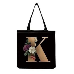 Canvas tote bag with stylish gold letter K and vintage floral print, black casual shoulder handbag.