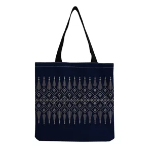 Detailed view of the dark blue canvas tote bag featuring intricate gold geometric patterns.