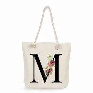 Leinen-Tragetasche mit schwarzem Buchstaben M und Blumen-Druck, lässige Strand-Umhängetasche.