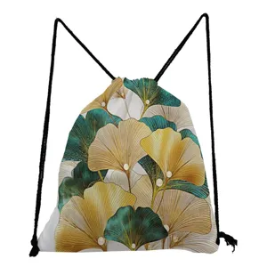 Close-up of the stylish ginkgo leaf pattern on this green and gold fabric drawstring bag.