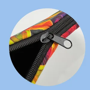 Colorful monstera leaf print cosmetic storage pouch closeup view featuring durable black zipper.