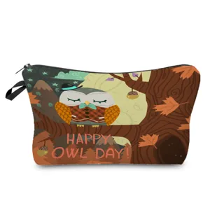 Detailed view of the cute autumn owl print cosmetic bag, featuring durable zipper and fabric tab.