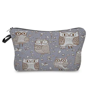 Detail view showing pattern details and zipper of grey owl printed cosmetic makeup bag.