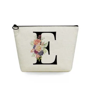 Canvas makeup bag detail featuring elegant floral letter E print and black zipper.