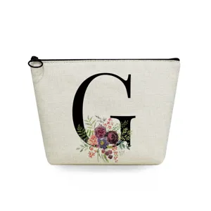 Close-up detail of the canvas makeup pouch featuring a elegant floral letter G print.