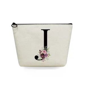 Close-up detail of the canvas cosmetic bag with black letter J and watercolor floral print.