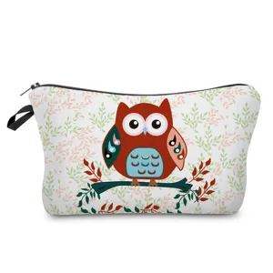 Close-up detail of the cute owl print makeup pouch, showing fabric texture and zipper design.