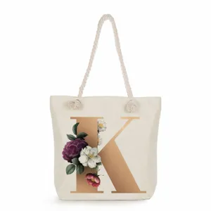 Canvas tote bag with elegant gold letter K print and vintage floral pattern for daily use.