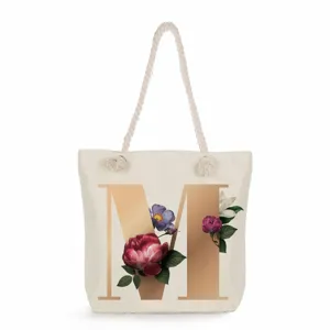 Canvas tote bag with golden letter M print, minimalist large capacity shoulder handbag for daily use.