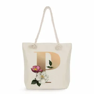 Beige canvas tote bag with gold letter P and floral print, casual shoulder bag for women.