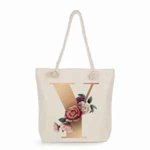 Canvas tote bag with gold letter Y and floral print, stylish large capacity shoulder handbag.